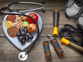 whole foods on heart shaped plate with fitness tools