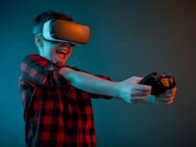 young boy playing video game with VR glasses
